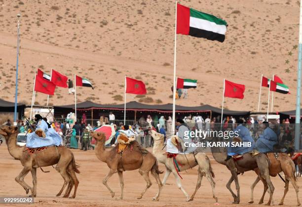 Camel-riders ride during the opening ceremony of the 14th Tan-Tan Moussem Berber festival in the western Moroccan desert town of Tan-Tan on July 6,...