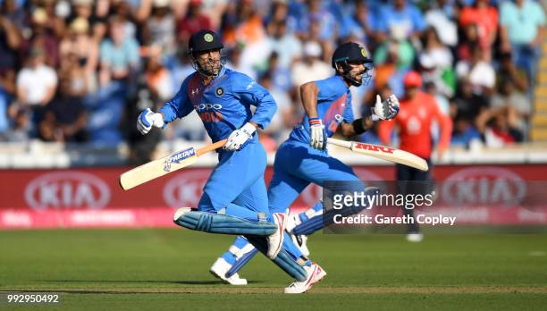 Dhoni and Virat Kohli of India score runs during the 2nd Vitality International T20 match between England and India at SWALEC Stadium on July 6, 2018...