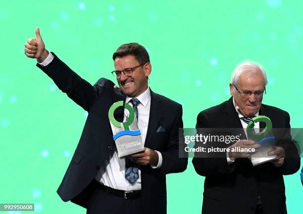 Award winners Johannes and Bernhard Oswald stand on stage during the ceremony of the German Environment Award of the German Federal Foundation for...