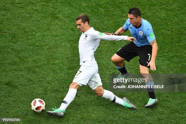 Uruguay's midfielder Cristian Rodriguez marks France's forward Antoine Griezmann during the Russia 2018 World Cup quarter-final football match...