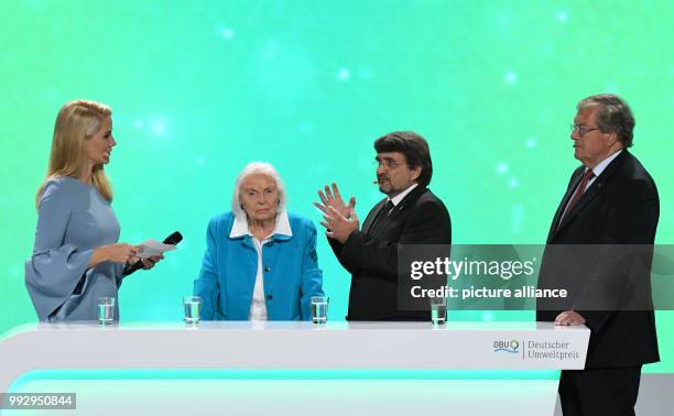 Host Judith Rakers and the award winners Inge Sielmann, Kai Frobel, Hubert Weiger stand on stage during the ceremony of the German Environment Award...