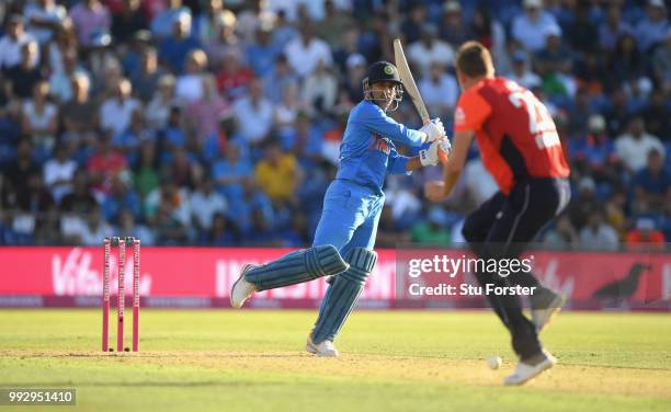 India batsman MS Dhoni clubs the ball past England bowler Jake Ball during the 2nd Vitality T20 International between England and India at Sophia...