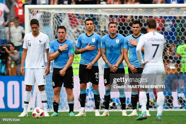 Uruguay's midfielder Cristian Rodriguez, Uruguay's midfielder Matias Vecino, Uruguay's defender Jose Gimenez get ready for a free kick during the...