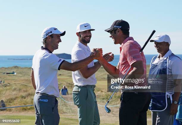 Edoardo Molinari of Italy celebrates with Erik van Rooyen of South Africa and Alvaro Velasco of Spain after he makes a hole in one on the par three...