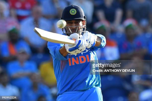 India's MS Dhoni plays a shot during the international Twenty20 cricket match between England and India at Sophia Gardens in Cardiff, south Wales, on...