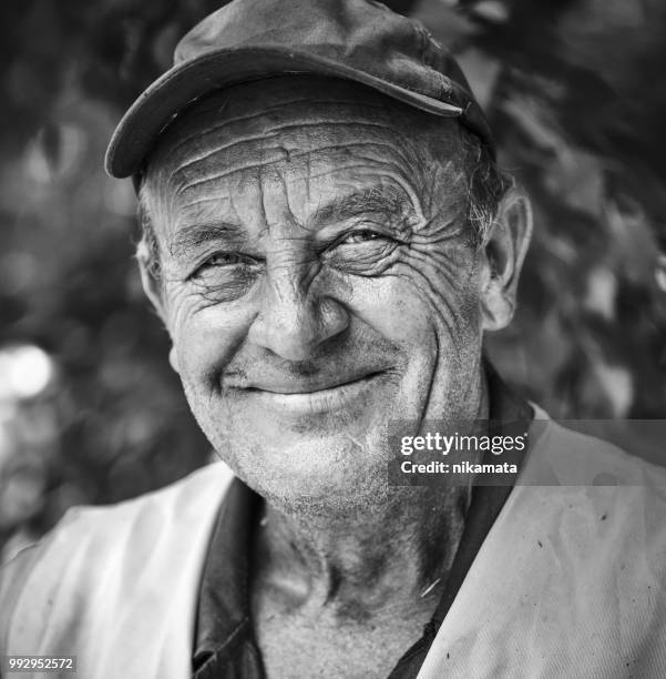 portrait of an elderly smiling man - farmer portrait stock pictures, royalty-free photos & images