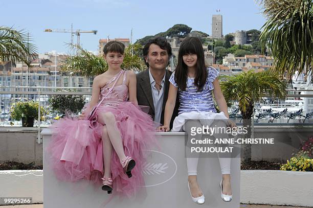 Romanian actor and director Cristi Puiu poses with actress Carmela Culda and actress Ileana Puiu during the photocall of "Aurora" presented in the Un...