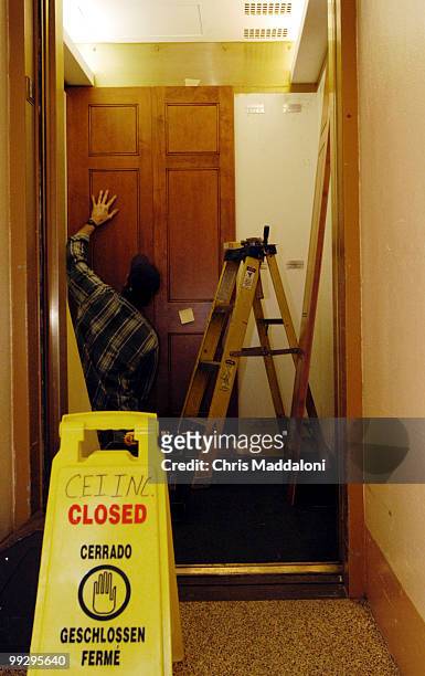 Ron Brown, a contractor with Chesapeake Elvators, installs new panelling in the Capitol on Jan. 2, 2004.
