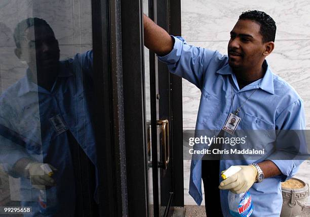 Robert Cuello cleans the doors of the Hart building at the Capitol on Jan. 2, 2004.