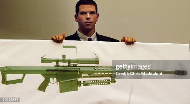 Staffer holds a life-size poster of a .50 caliber gun that could be made legal during testifmony at a House Government Reform Committee hearing on...
