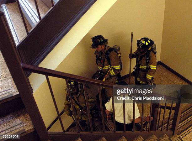 Fire fighters gather in the basement of the Hart building, for a fire in a dumpster in the basement.