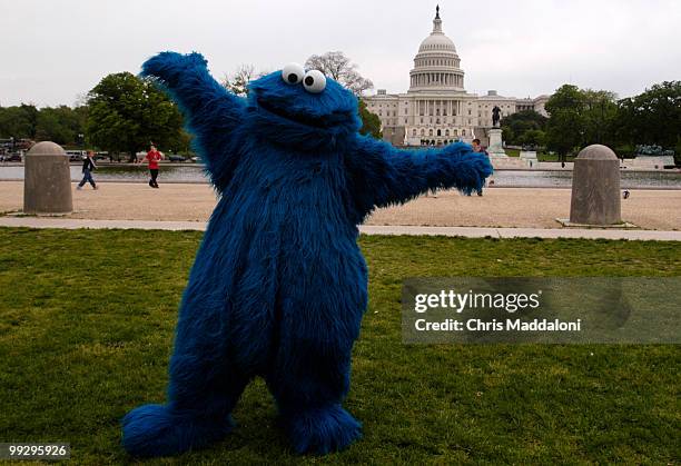 Cookie Monster poses at a fair to kick off National Physical Fitness and Sports Month on the Mall.