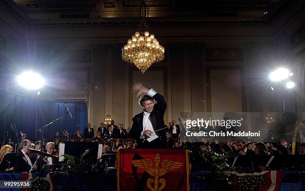Victor Wahby conducts the "National Emblem March" with the VA-National Medical Musical Group orchestra and chorale at the 2004 Congressional Falg and...