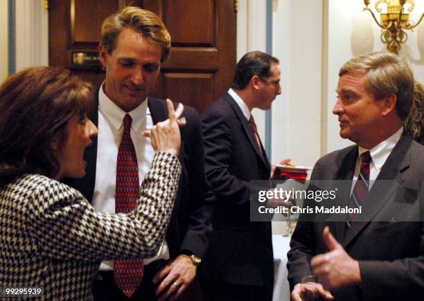 Rep. Jeff Flake, R-Az. And his wife, Cheryl, greet Rep. Robert Ney, R-Oh. At a spouse meet n' greet before the State of the Union.