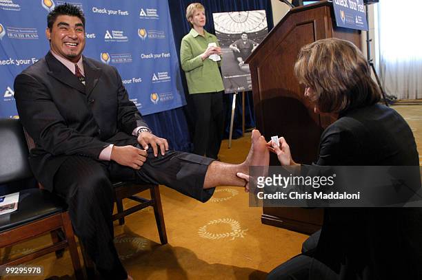 Roberto Garza, lineman for the Atlanta Falcons, gets his feet checked out by Dr. Francine Kaufman, President of the America Diabetes Association....
