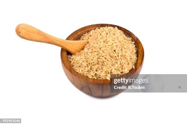rice in wooden bowl on white background - makrobiotik stock-fotos und bilder