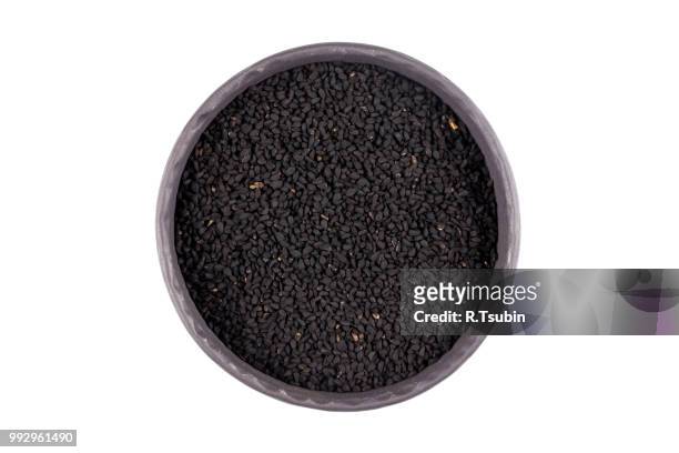 sesame black seeds in stone bowl isolated on white background - macrobiotic diet stock pictures, royalty-free photos & images