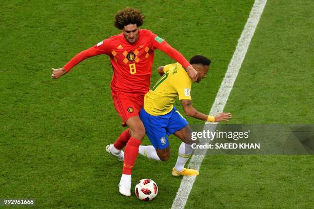 Belgium's midfielder Marouane Fellaini fouls Brazil's forward Neymar during the Russia 2018 World Cup quarter-final football match between Brazil and...