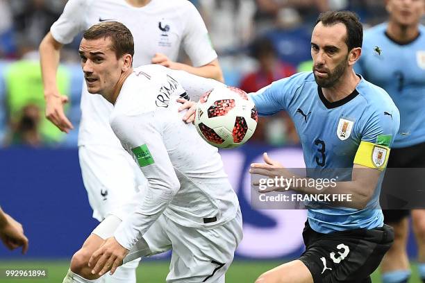 France's forward Antoine Griezmann vies with Uruguay's defender Diego Godin during the Russia 2018 World Cup quarter-final football match between...