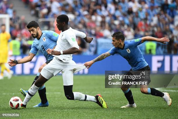 France's midfielder Paul Pogba vies with Uruguay's forward Luis Suarez and Uruguay's midfielder Lucas Torreira during the Russia 2018 World Cup...