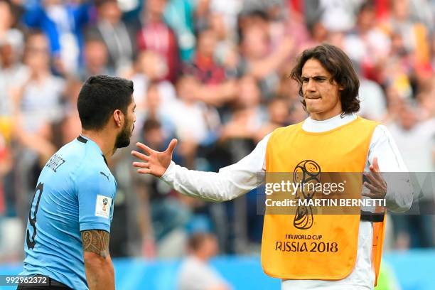 Uruguay's forward Edinson Cavani comforts Uruguay's forward Luis Suarez after the team lost the Russia 2018 World Cup quarter-final football match...