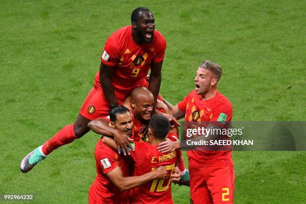 Belgium's forward Romelu Lukaku jumps over teammates to celebrate Brazil's own goal during the Russia 2018 World Cup quarter-final football match...