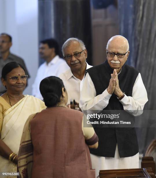 External Affairs Minister Sushma Swaraj greets Senior BJP leader L K Advani before paying floral tribute, to Syama Prasad Mookerjee, on his birth...