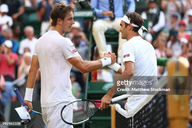 Roger Federer of Switzerland shakes hands with Jan-Lennard Struff of Germany after their Men's Singles third round match on day five of the Wimbledon...