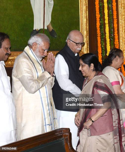 Prime Minister Narendra Modi greets External Affairs Minister Sushma Swaraj as Senior BJP leader L K Advani and Deputy Speaker of Lok Sabha Thambi...