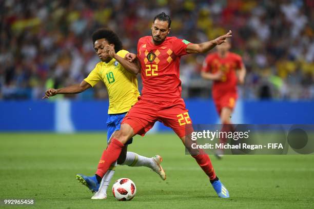 Willian of Brazil battles for possession with Nacer Chadli of Belgium during the 2018 FIFA World Cup Russia Quarter Final match between Brazil and...