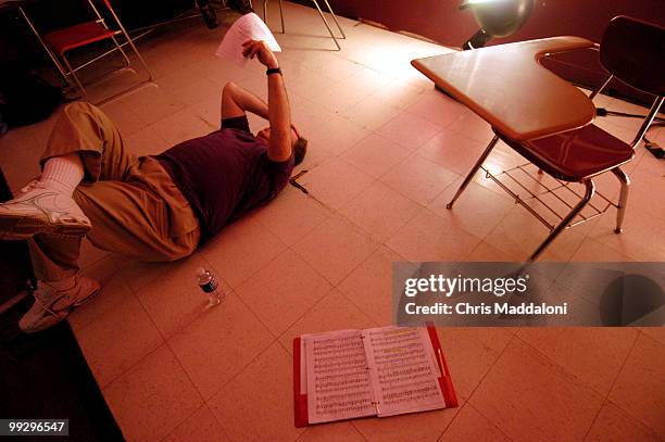 Ken Rynne studies his lines for the part of Bud Noir at rehearsal for the Hexagon 2006 "You Only Run Twice," which opens March 3 at the Duke...
