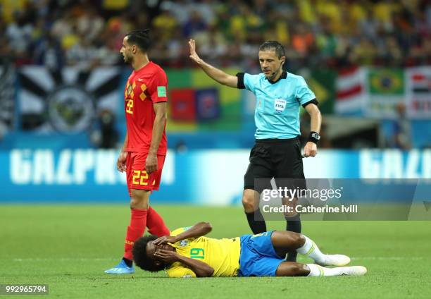 Referee Milorad Mazic checks Willian of Brazil conditions during the 2018 FIFA World Cup Russia Quarter Final match between Brazil and Belgium at...