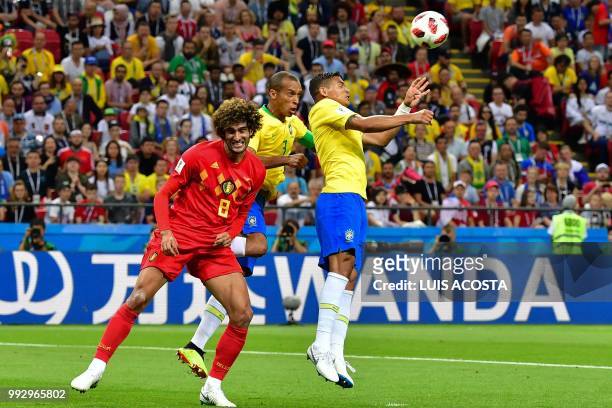 Belgium's midfielder Marouane Fellaini vies for the ball with Brazil's defender Miranda and Brazil's defender Thiago Silva during the Russia 2018...