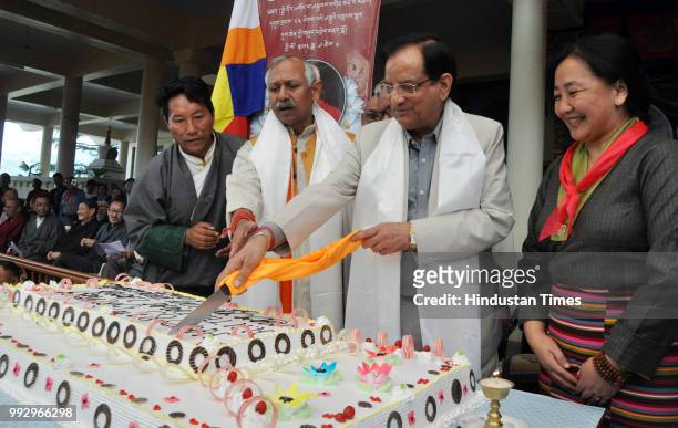 Himachal Pradesh Food & Civil Supplies Minister Kishan Kapoor along with Tibetans living-in-exile in India cut a birthday cake as they celebrate the...