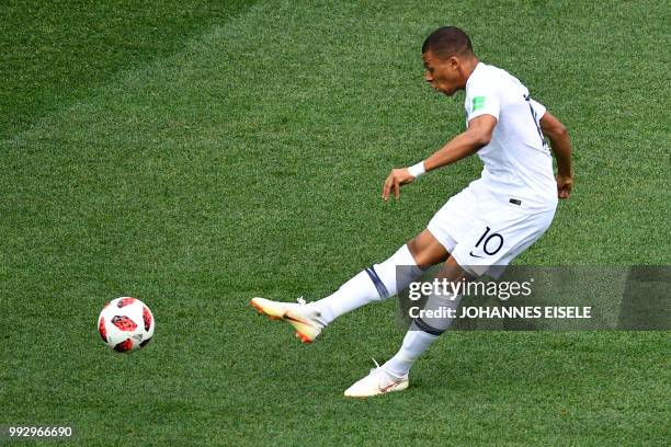 France's forward Kylian Mbappe takes a shot during the Russia 2018 World Cup quarter-final football match between Uruguay and France at the Nizhny...