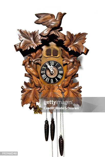 classic wood-carved black forest cuckoo clock, the hands are stopped at eleven fifty-five, germany - cuckoo clock stock-fotos und bilder