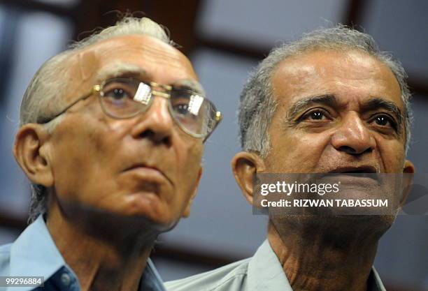 Pakistani stockbrokers look at the latest share prices on a monitor during a trading session at the Karachi Stock Exchange on May 14, 2010. The...