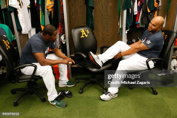 Santiago Casilla and Yusmeiro Petit of the Oakland Athletics talk in the clubhouse prior to the game against the Kansas City Royals at the Oakland...