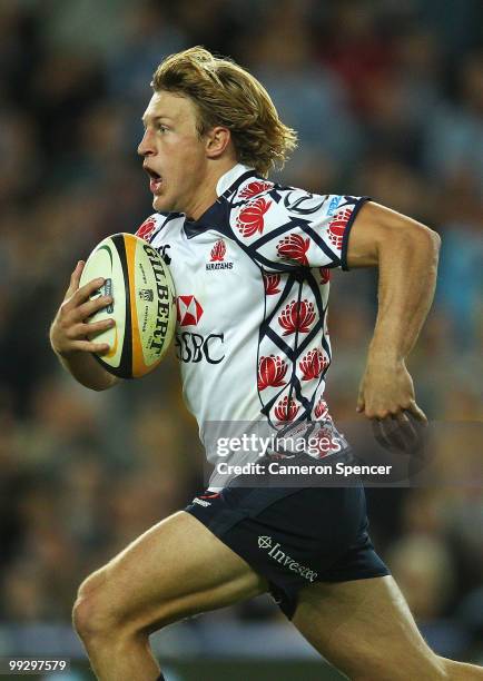 Lachie Turner of the Waratahs runs the ball during the round 14 Super 14 match between the Waratahs and the Hurricanes at Sydney Football Stadium on...