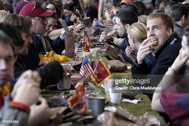 Staffers chow on MREs at Marine Day 2004. The MRE had a variety of flavors, like cheesee tortellini to beef stew - "some tasting better than others,"...