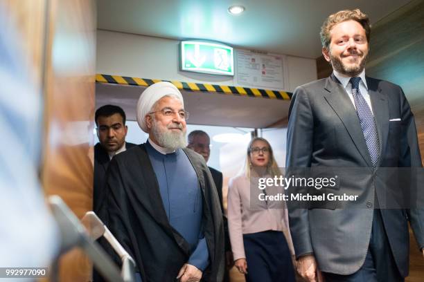 Iranian President Hassan Rouhani and President of the Austrian Chamber of Commerce Harald Mahrer arrive at the Austrian Economic Chamber on July 4,...