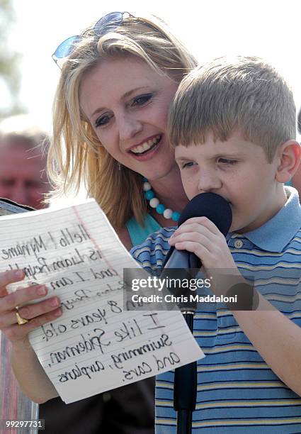 Shelly Reynolds, from Baton Rouge, La., helps her autistic son, Liam open an Autism research and education rally on the West Front of the Capitol....