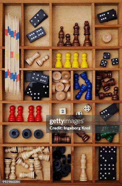 wooden figures of board games, gaming pieces, dice, dominoes, mikado sticks, games collection in a letter case - mikado stock pictures, royalty-free photos & images