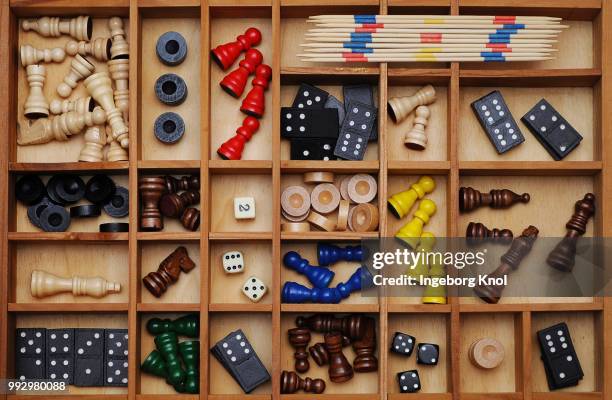 wooden figures of board games, gaming pieces, dice, dominoes, mikado sticks, games collection in a letter case - mikado stock pictures, royalty-free photos & images