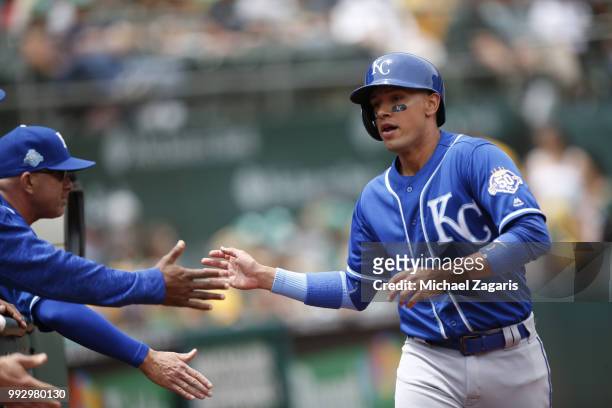 Ryan Goins of the Kansas City Royals is congratulated at the dugout during the game against the Oakland Athletics at the Oakland Alameda Coliseum on...