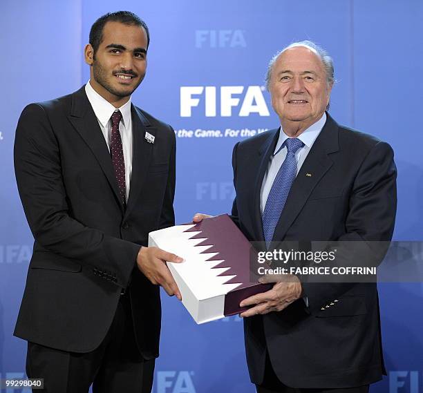 Chairman of Quatar 2022 bid committee Sheik Mohammed bin Hamad Al Thani delivers the bid book to FIFA president Sepp Blatter during an official...