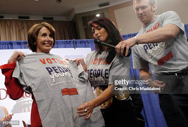 Victoria, the WWE Women's Wrestling Champion, and WWE wrestler Chritopher Nowinski present House Minority Leader Nancy Pelosi, D-Ca., with a T-shirt...