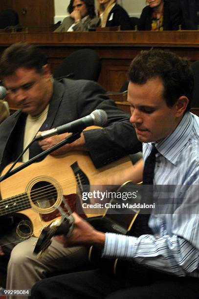 Mark Allan Burnette and Troy Verges perform at the "Guitar Pull," an event sponsored by the new Songwriters Caucus, to promote online piracy...