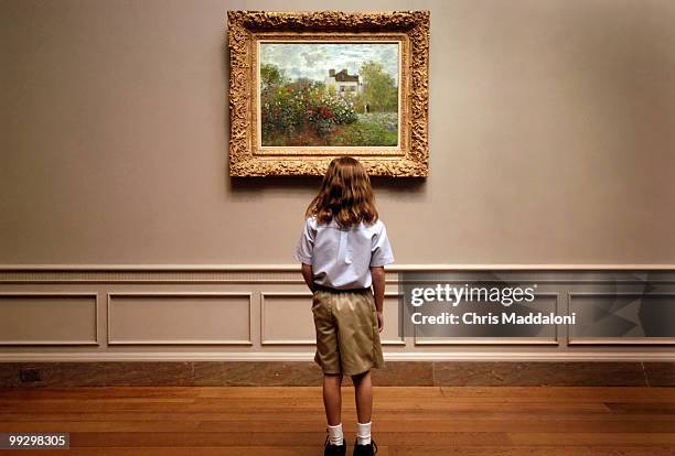 Girl from Herndon's Ambleside School looks at Claude Monet's "The Artist's Garden in Argenteuil" at the National Gallery of Art.