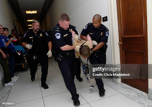 Police carry away protesters from Rep. Joe Barton's office in Rayburn. Members of the American Disabled for Attendant Programs Today held protests...